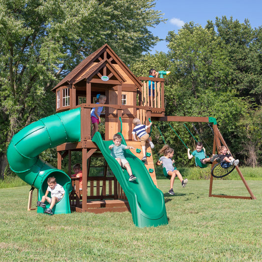 Backyard Discovery Skyfort All Cedar Swing Set, Elevated Covered Wood Roof Clubhouse with Bay Windows, 2 Belt Swings, Web Swing, 10ft Wave Slide, 5 ft Tube Slide, Covered Picnic Table, 5 ft Rock Wall
